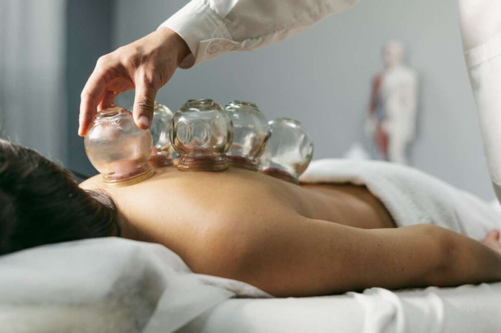 Glass bowl therapy setup during Ayurvedic back treatment at spa in Mumbai